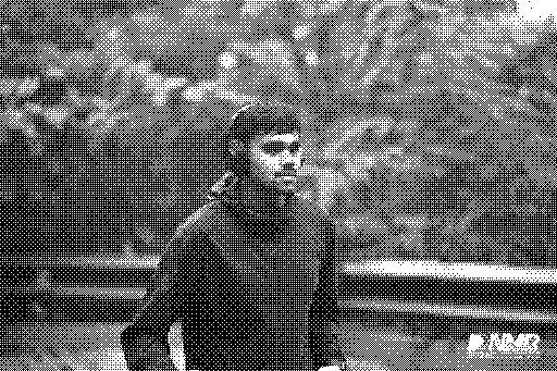 A runner wearing headphones at DNMR 2026, rendered in black-and-white dithering.